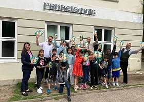 Grundschulkinder der Fröbelschule freuen sich über das Hausaufgabenheft