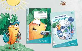 Kiki Karotte präsentiert das NAH.SH-Hausaufgaben- und Rätselheft im NAH.SH-Design