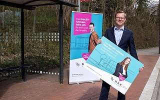 Staatssekretär Dr. Thilo Rohlfs in Bushaltestelle und NAH.SH Aufsteller